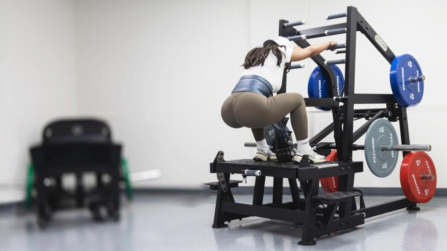 Hip Thrust vs. Squat: What Actually Builds Glutes? 2 Athlete training on the GluteZone belt squat machine