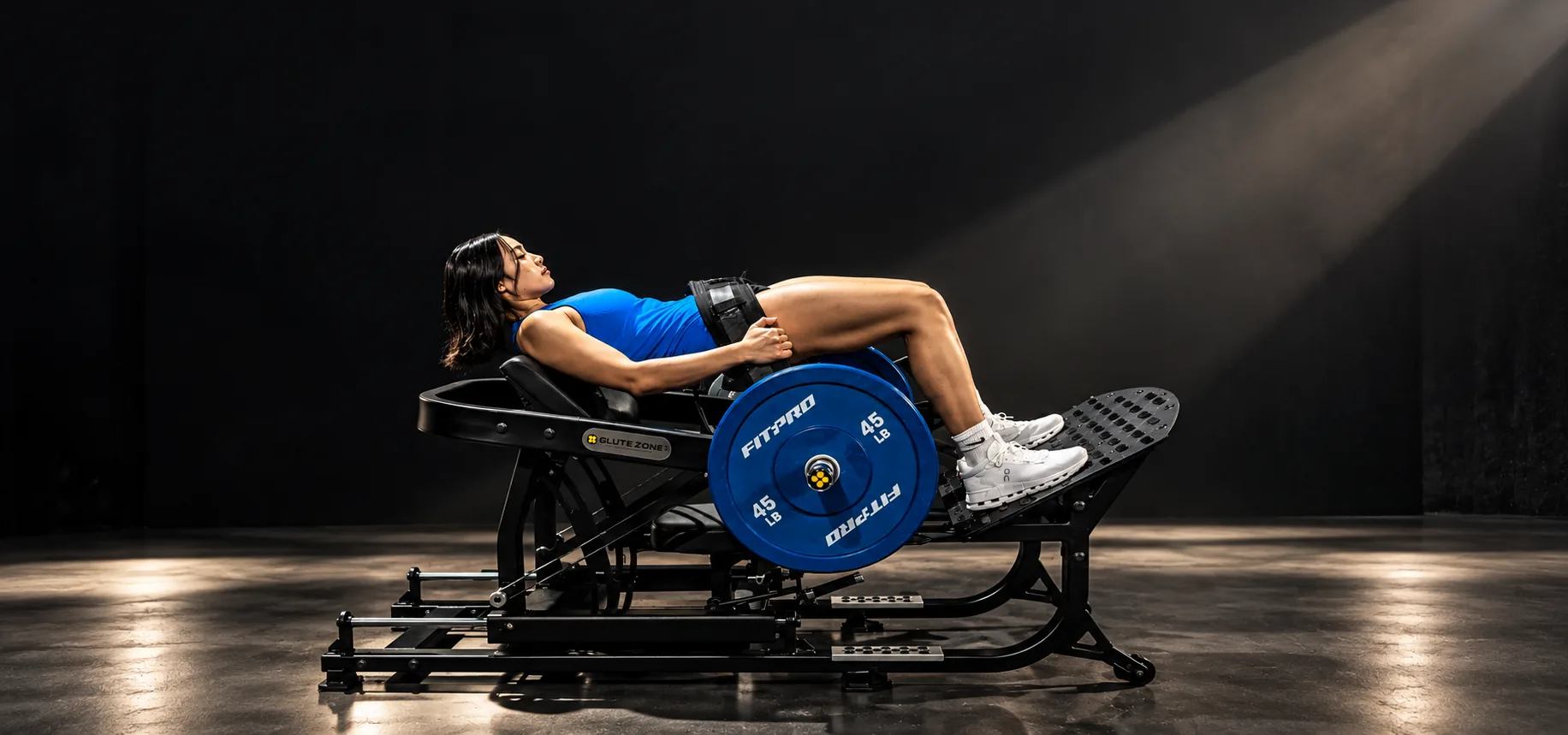 Hip Thrust Setup Guide: 16 Positions for Every Body Type 4 Athlete performing hip thrusts on the GluteZone hip thrust machine in a commercial gym