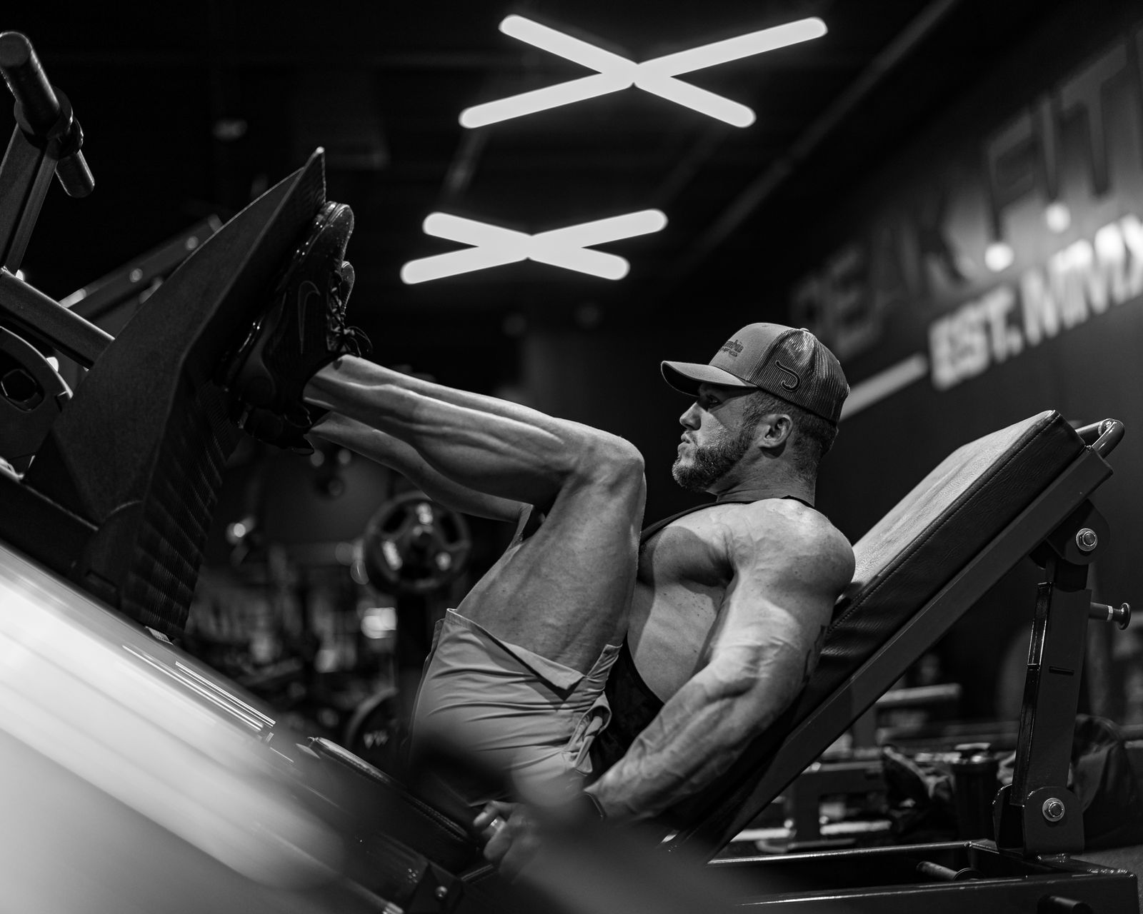 The Loaded Stretch: Why Deep Hip Extension Builds Bigger Glutes 1 Athlete at the bottom of a leg press with knees deeply bent, muscles under load at long length